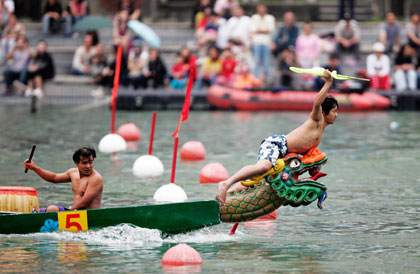 The leader of a dragon boat takes the victory flag as his team nears the finish line during a race in Taipei May 31, 2006. The Dragon Boat festival is commemorated in memory of the patriotic poet Qu Yuan, who drowned on the day in 277 B.C.