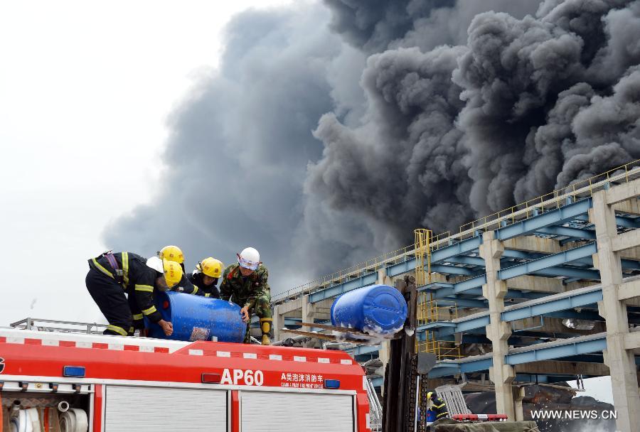 Firefighters try to extinguish the fire at a chemical plant on the Gulei Peninsula in Zhangzhou, southeast China's Fujian Province, April 8, 2015.