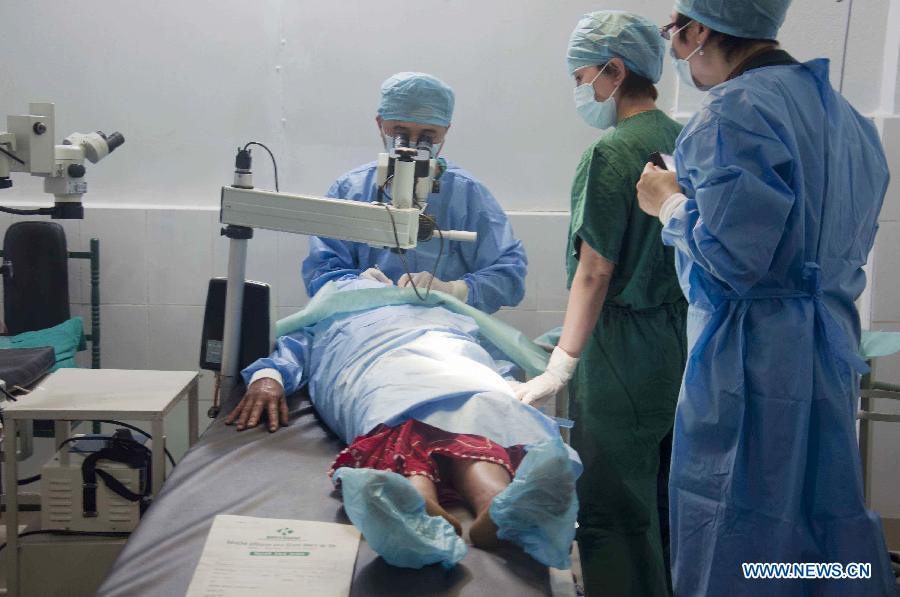 Chinese doctors conduct an eye operation during a free health camp in Barabishey, Nepal, March 27, 2014. A dedicated team of Chinese doctors from Chengdu Aidi Eye Hospital organized a free eye health camp here on Thursday. (Xinhua/Pratap Thapa)