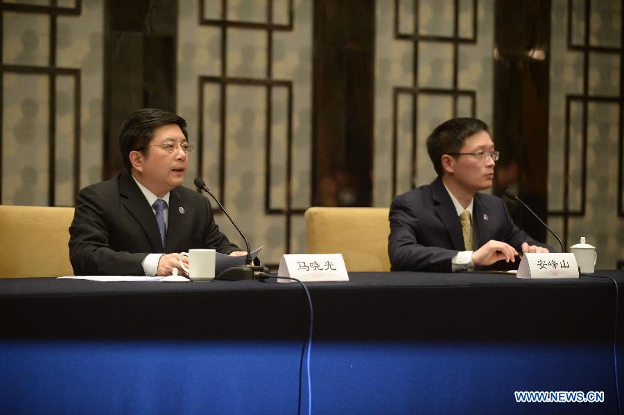 Ma Xiaoguang (L), spokesman of the State Council Taiwan Affairs Office, attends a press conference in Nanjing, capital of east China's Jiangsu Province, Feb. 11, 2014.