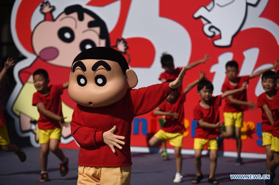 Children dance during the launching ceremony of the exhibition marking the 25th anniversary of Japanese manga series Crayon Shin-chan in Shenyang, northeast China's Liaoning Province, July 8, 2015.