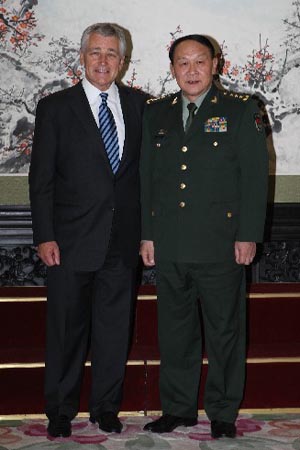 Liang shakes hands with visiting U.S. Senator Chuck Hagel.